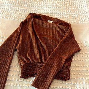 Size medium. Bronze colored off the shoulder women’s sweater. Never worn.